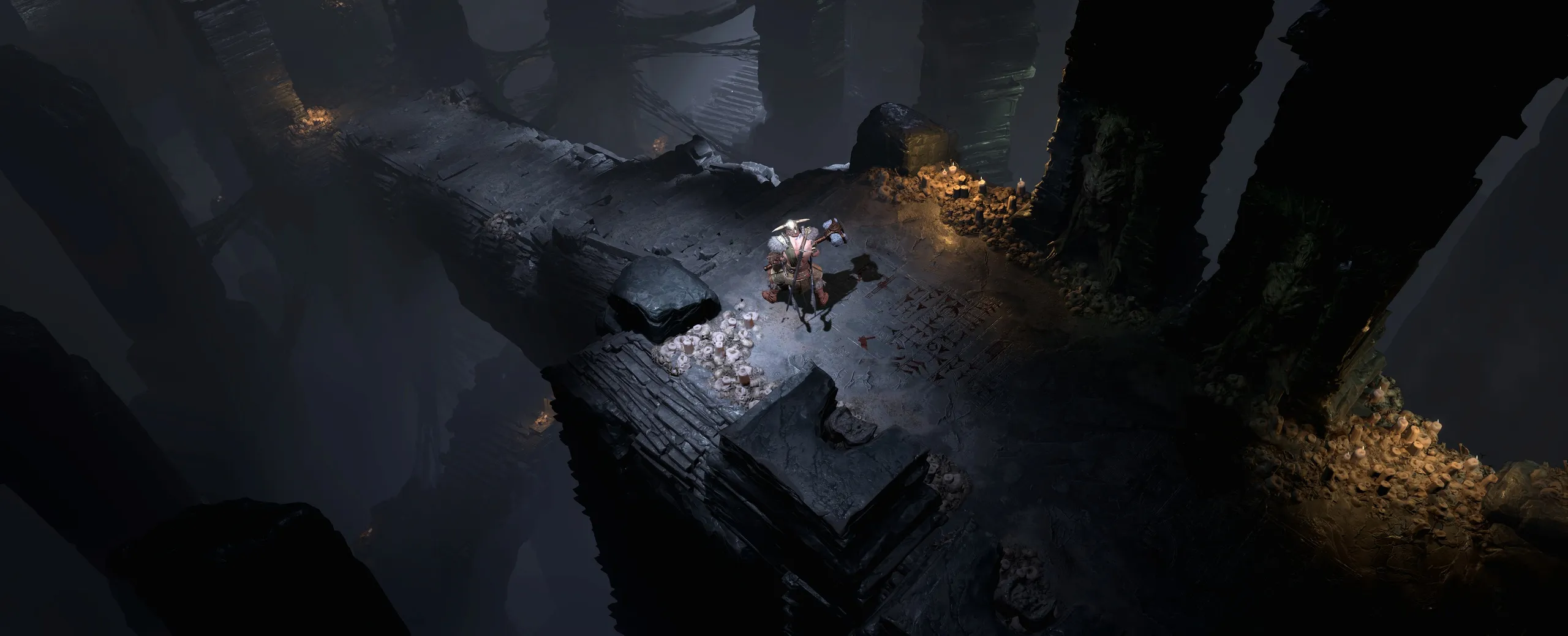 A lone armored figure on a candlelit stone ledge above a dark chasm